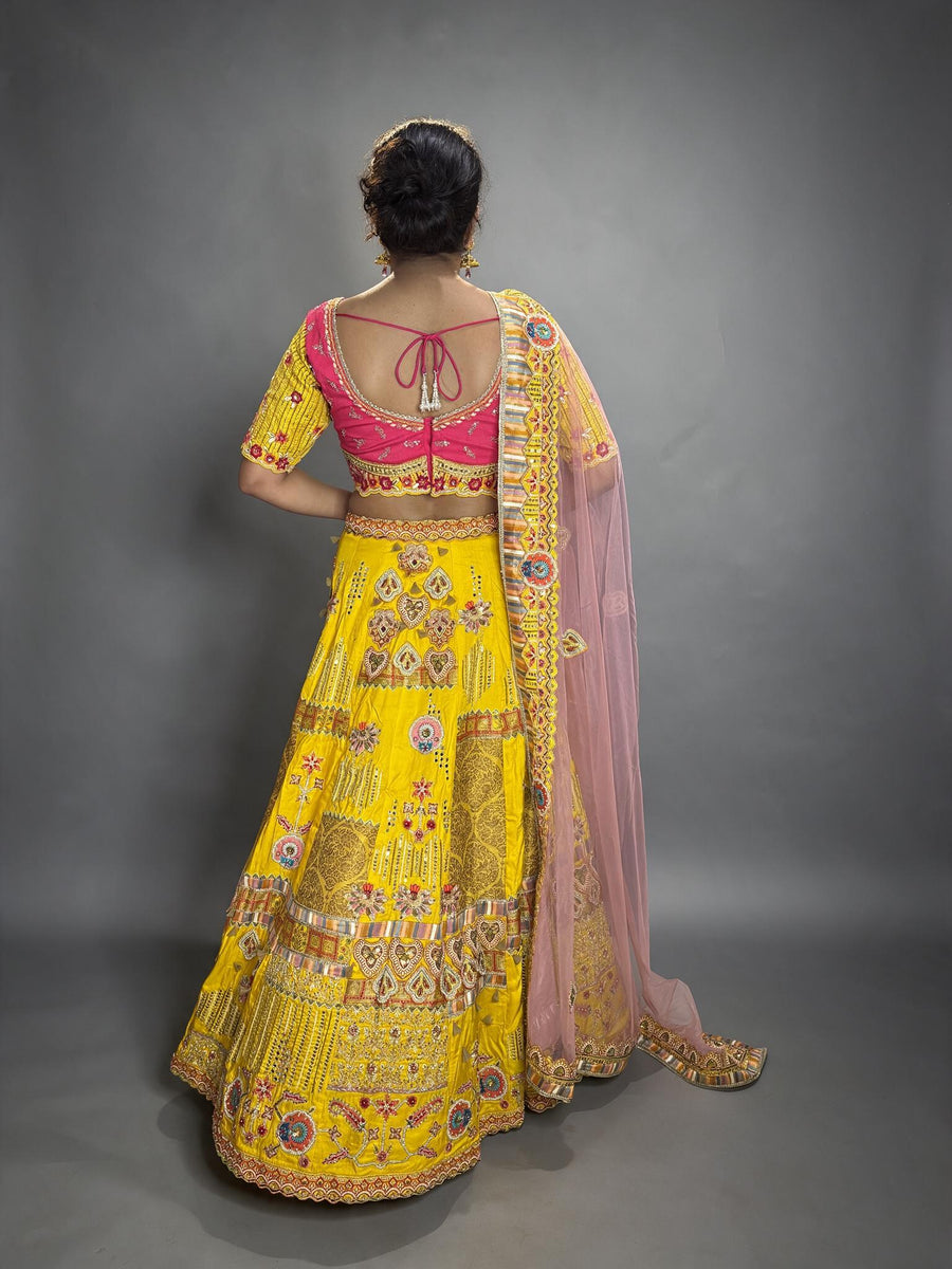 Yellow Silk Flared Kali Lehenga With Mirror Work — back view